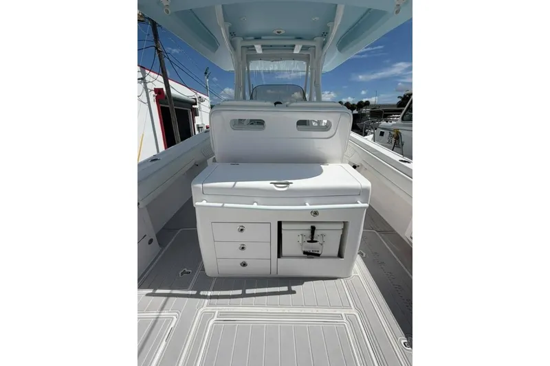 Slide: The Image of 2020 Intrepid 375 Nomad SE boat interior with seating and storage compartments. - 8