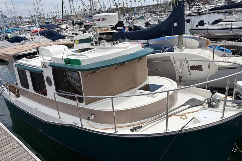 The Image of 2008 Ranger Tugs R-25 boat docked in a marina, surrounded by other vessels. - 0
