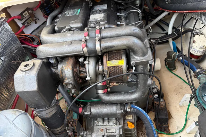 Slide: The Image of Engine compartment of a 2008 Ranger Tugs R-25 boat, showcasing mechanical components and wiring. - 17