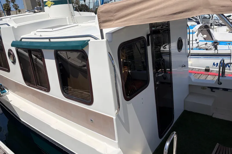 Slide: The Image of 2008 Ranger Tugs R-25 boat docked, featuring a white exterior and tinted windows. - 4