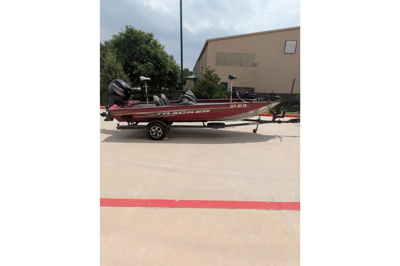 The Image of 2019 Tracker Pro Team 190 boat on trailer, parked outdoors. - 1