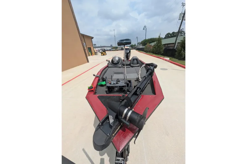 Slide: The Image of 2019 Tracker Pro Team 190 boat on a concrete driveway, featuring a red exterior. - 3