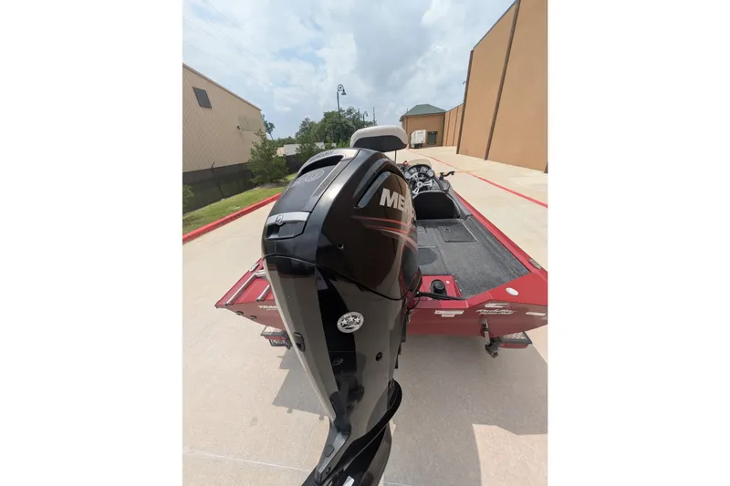 Slide: The Image of 2019 Tracker Pro Team 190 boat with Mercury outboard motor, parked outdoors. - 4