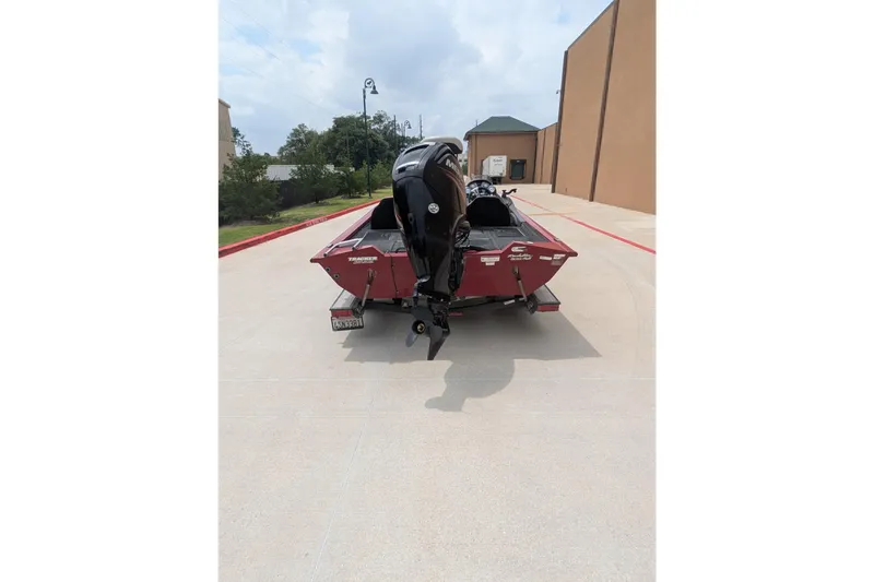 Slide: The Image of 2019 Tracker Pro Team 190 boat with outboard motor on a concrete driveway. - 7