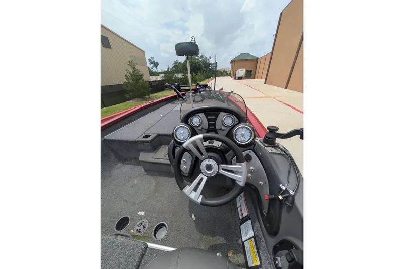Slide: The Image of 2019 Tracker Pro Team 190 boat dashboard with steering wheel and gauges. - 9