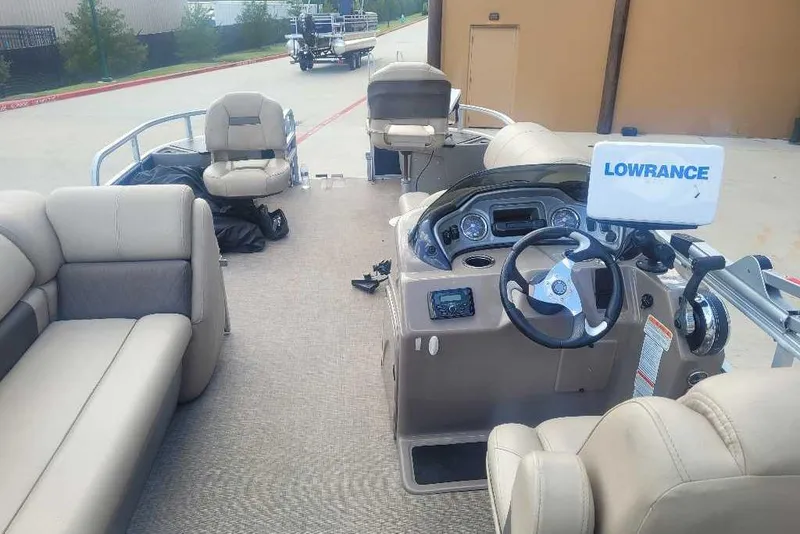 Slide: The Image of 2022 Sun Tracker Fishin' Barge 22 DLX interior with steering console and seating. - 2