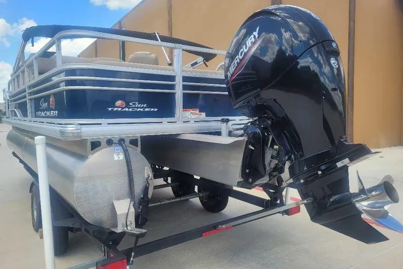 Slide: The Image of 2022 Sun Tracker Fishin' Barge 22 DLX pontoon boat with Mercury outboard motor. - 5