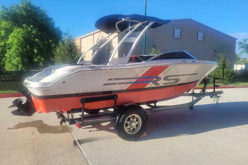 Slide: The Image of 2016 Four Winns H200RS boat on trailer, featuring sleek design and vibrant colors. - 1