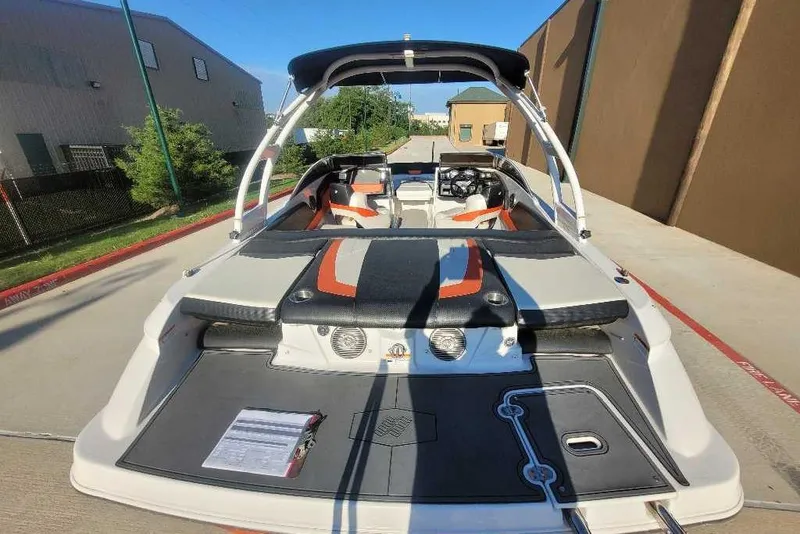 Slide: The Image of 2016 Four Winns H200RS boat with sleek design, parked outdoors. - 3