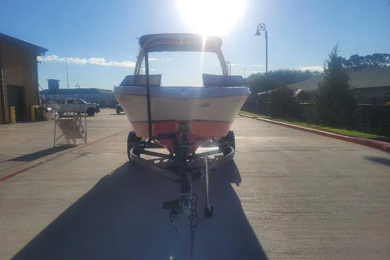 Slide: The Image of 2016 Four Winns H200RS boat on trailer, parked outdoors under bright sunlight. - 4