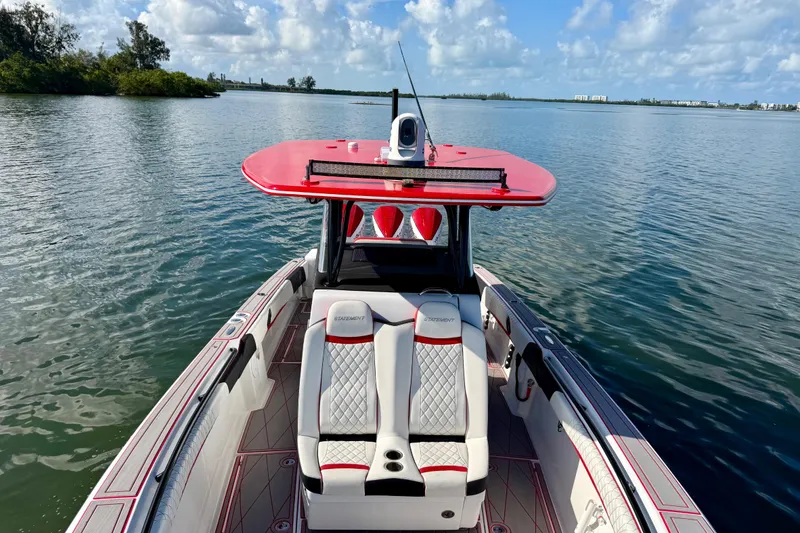 Slide: The Image of 2023 Statement 350 Open boat on calm water, featuring sleek design and vibrant red accents. - 12