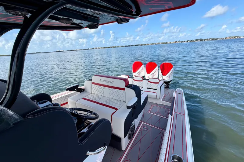 Slide: The Image of 2023 Statement 350 Open boat with luxurious seating and powerful engines on a serene lake. - 21