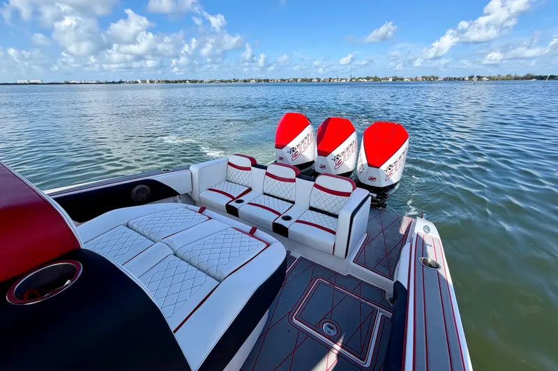 Slide: The Image of Luxurious 2023 Statement 350 Open boat with triple engines on a serene water backdrop. - 24
