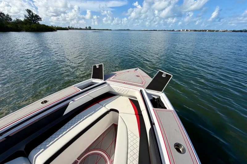 Slide: The Image of 2023 Statement 350 Open boat on calm water, featuring sleek seating and storage compartments. - 29