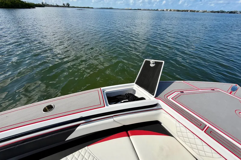 Slide: The Image of 2023 Statement 350 Open boat on calm water, featuring sleek design and open storage compartment. - 30