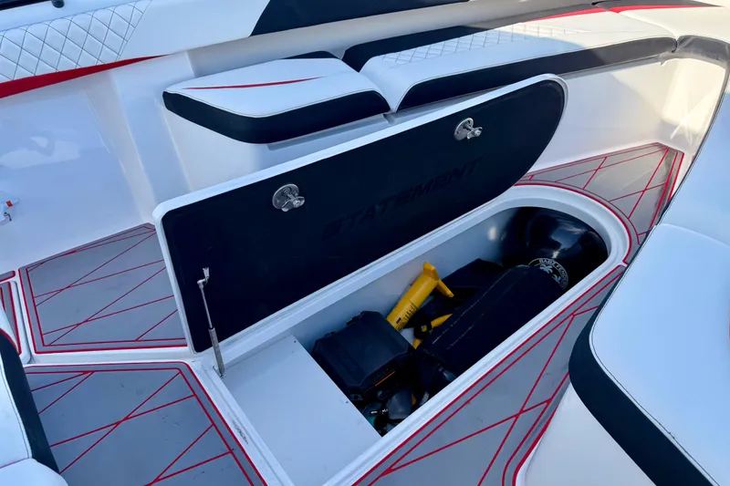Slide: The Image of 2023 Statement 350 Open boat storage compartment with seating and red accents. - 32