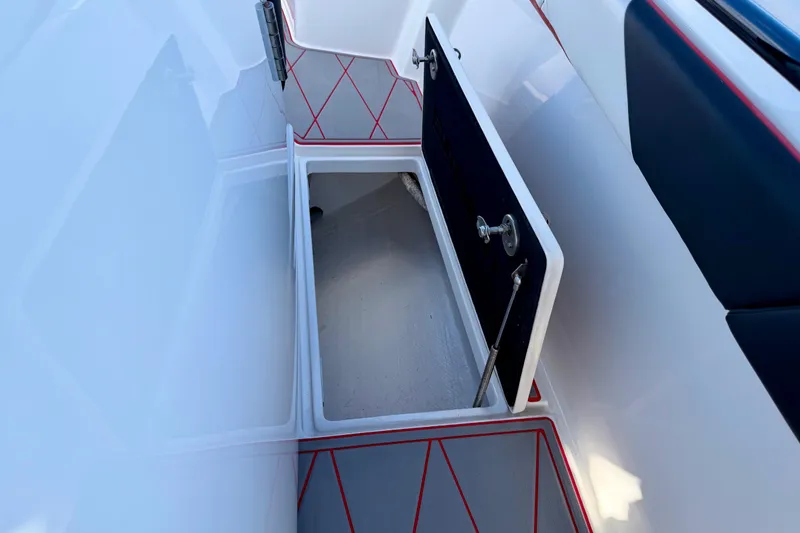 Slide: The Image of Open storage compartment on 2023 Statement 350 Open boat, featuring sleek design and red accents. - 33