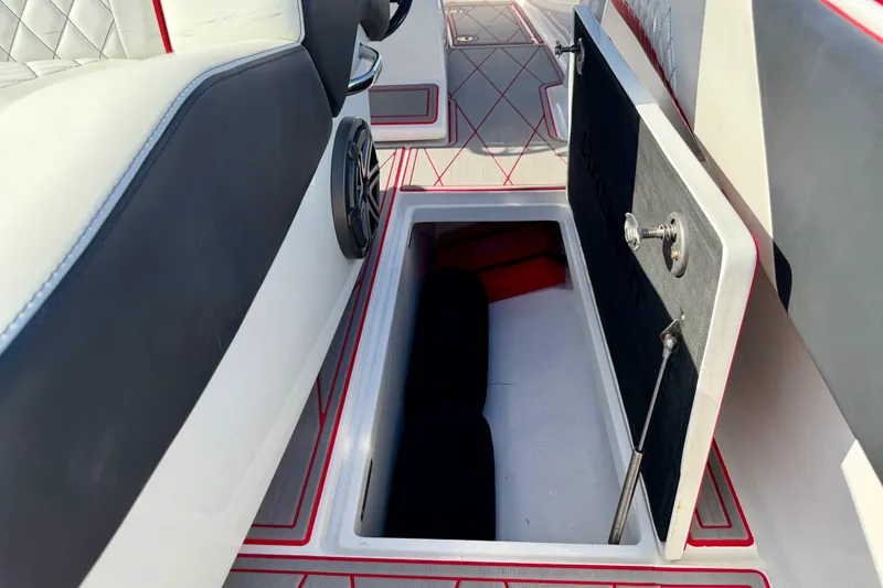 Slide: The Image of 2023 Statement 350 Open boat interior storage compartment with cushioned seating and speaker. - 34