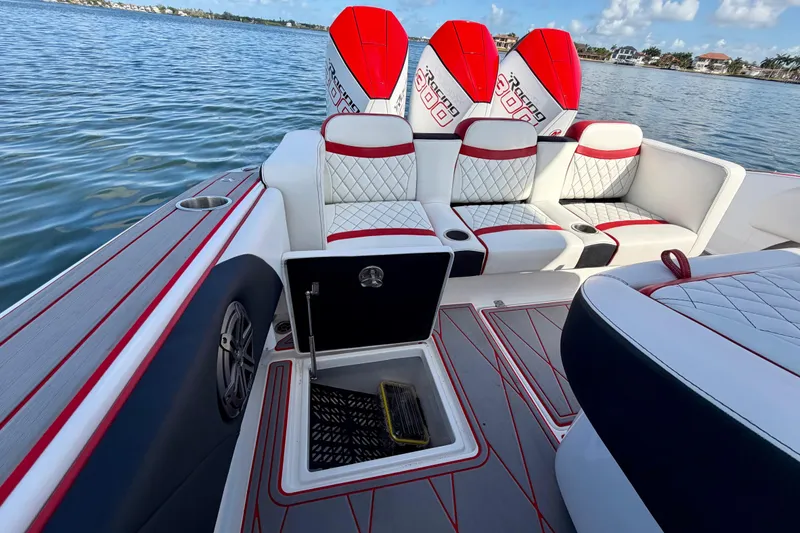 Slide: The Image of 2023 Statement 350 Open boat interior with stylish seating and powerful engines on a calm lake. - 35
