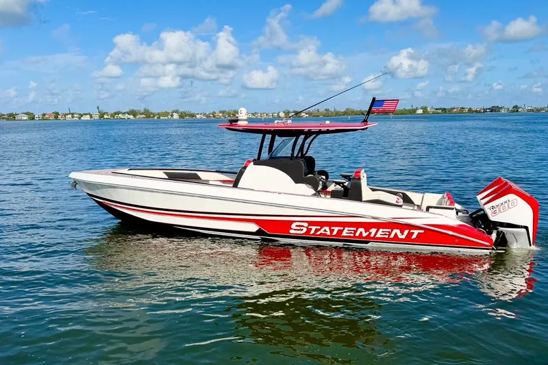 Slide: The Image of 2023 Statement 350 Open boat on calm water, featuring sleek red and white design. - 7