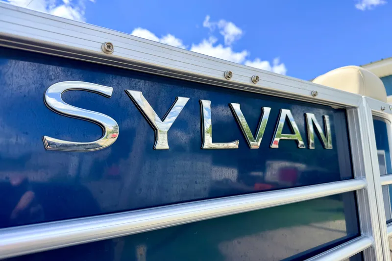 Slide: The Image of 2018 Sylvan 8522 Mirage Fish boat logo against a blue sky background. - 10