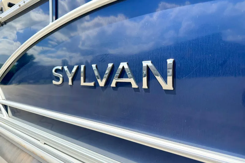 Slide: The Image of Close-up of 2018 Sylvan 8522 Mirage Fish boat logo on blue surface. - 14
