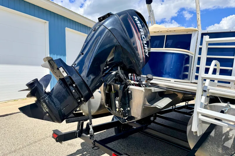 Slide: The Image of 2018 Sylvan 8522 Mirage Fish boat with Mercury outboard motor, parked outdoors. - 16