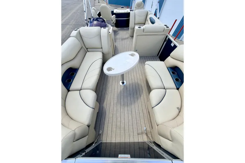 Slide: The Image of 2018 Sylvan 8522 Mirage Fish pontoon boat with beige seating and central table. - 21