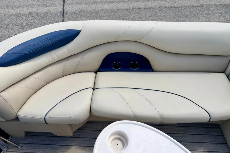 Slide: The Image of 2018 Sylvan 8522 Mirage Fish boat interior with cream seating and cup holders. - 22