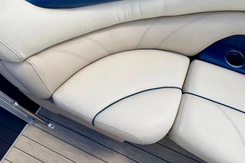 Slide: The Image of 2018 Sylvan 8522 Mirage Fish boat interior with beige and blue cushioned seating. - 23