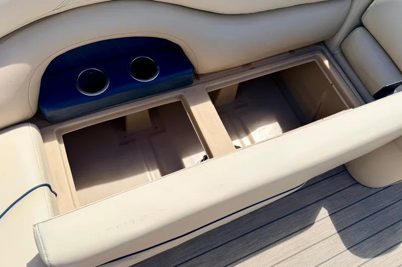Slide: The Image of 2018 Sylvan 8522 Mirage Fish boat storage compartment with cup holders, beige upholstery. - 26