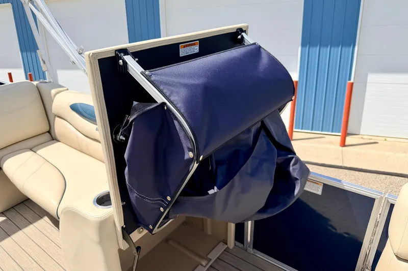 Slide: The Image of 2018 Sylvan 8522 Mirage Fish boat with blue storage compartment and beige seating. - 33