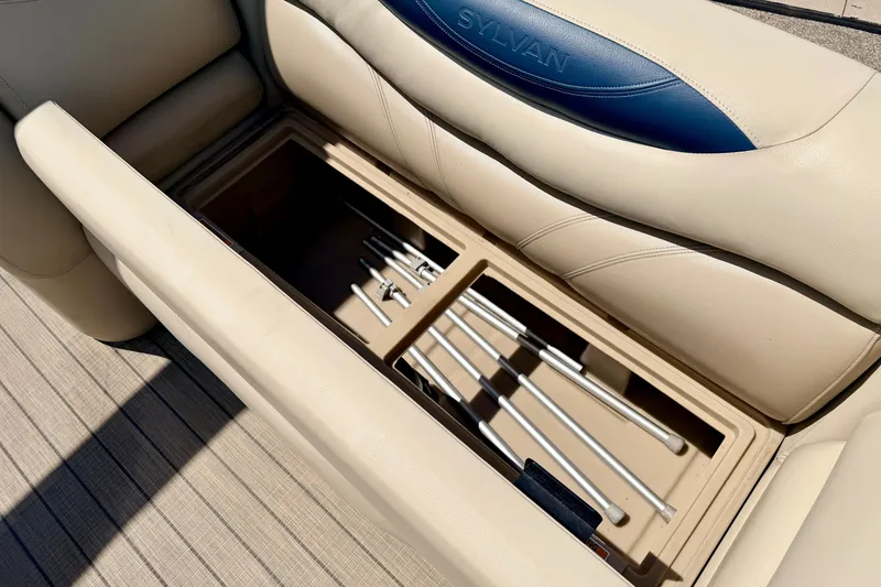 Slide: The Image of Storage compartment in 2018 Sylvan 8522 Mirage Fish boat with beige seating and rod holders. - 37