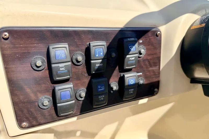 Slide: The Image of Control panel of 2018 Sylvan 8522 Mirage Fish boat with labeled switches. - 41