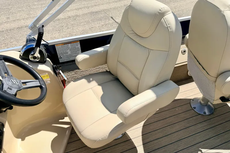 Slide: The Image of 2018 Sylvan 8522 Mirage Fish boat interior with beige captain's chair and steering wheel. - 47