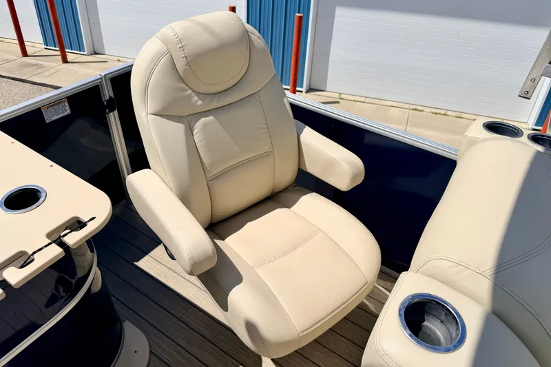 Slide: The Image of Luxurious beige captain's chair on 2018 Sylvan 8522 Mirage Fish boat, featuring cup holders. - 49