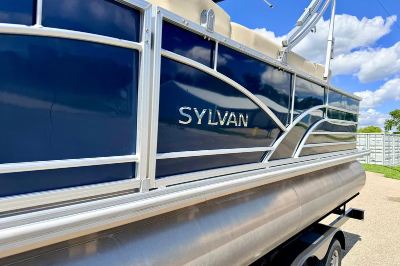 Slide: The Image of 2018 Sylvan 8522 Mirage Fish pontoon boat with sleek blue exterior and silver accents. - 5