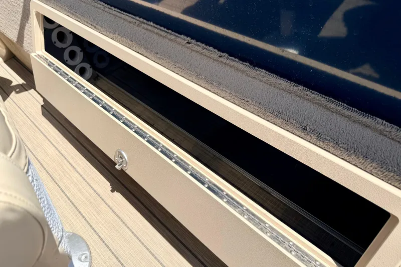 Slide: The Image of Storage compartment on 2018 Sylvan 8522 Mirage Fish boat, featuring secure latch and sleek design. - 57