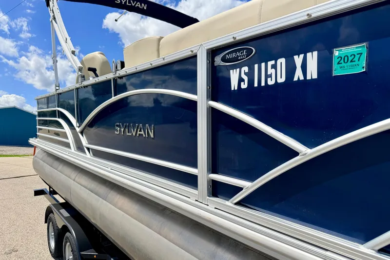 Slide: The Image of 2018 Sylvan 8522 Mirage Fish pontoon boat with registration details, parked outdoors. - 6