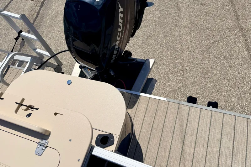 Slide: The Image of 2018 Sylvan 8522 Mirage Fish boat with Mercury outboard motor, docked on textured surface. - 60