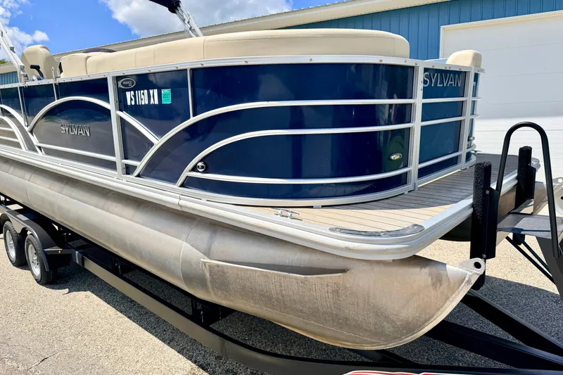 Slide: The Image of 2018 Sylvan 8522 Mirage Fish pontoon boat on trailer, blue exterior, sunny day. - 7