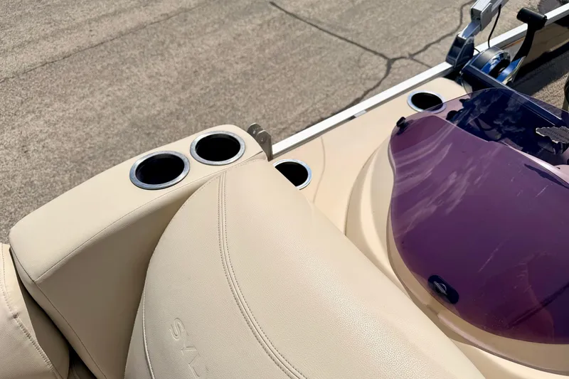 Slide: The Image of 2018 Sylvan 8522 Mirage Fish boat interior with cup holders and purple windshield. - 71