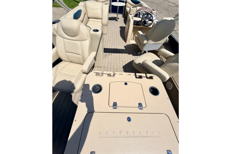 Slide: The Image of 2018 Sylvan 8522 Mirage Fish boat interior with beige seating and steering console. - 75