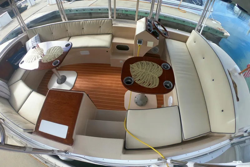 Slide: The Image of Interior of 2008 Duffy Snug Harbor 18 boat with elegant seating and wooden tables. - 1
