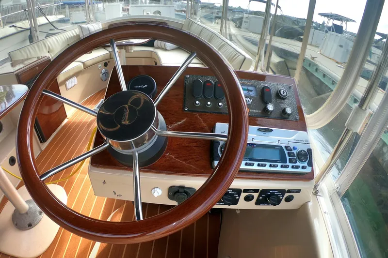 Slide: The Image of Interior view of 2008 Duffy Snug Harbor 18 boat cockpit with wooden steering wheel. - 3