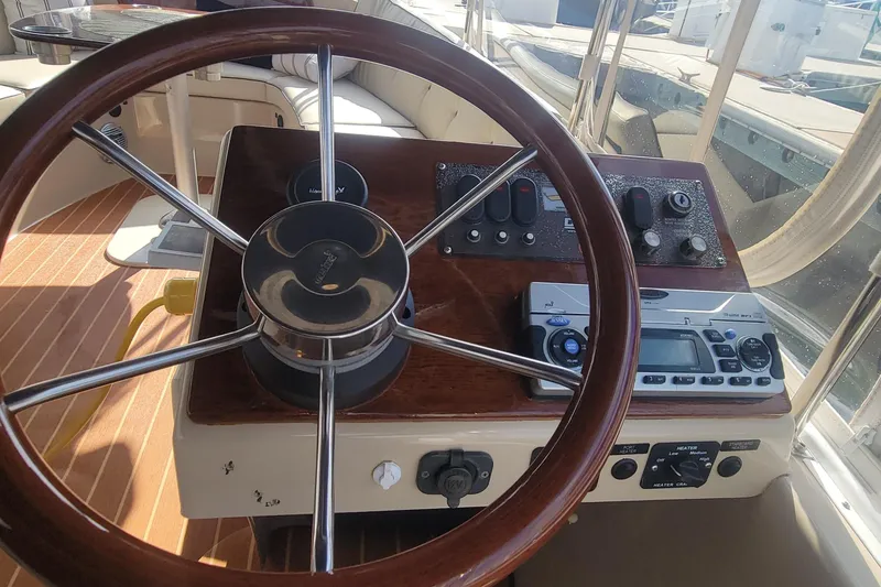 Slide: The Image of Steering wheel and controls of a 2008 Duffy Snug Harbor 18 boat. - 4