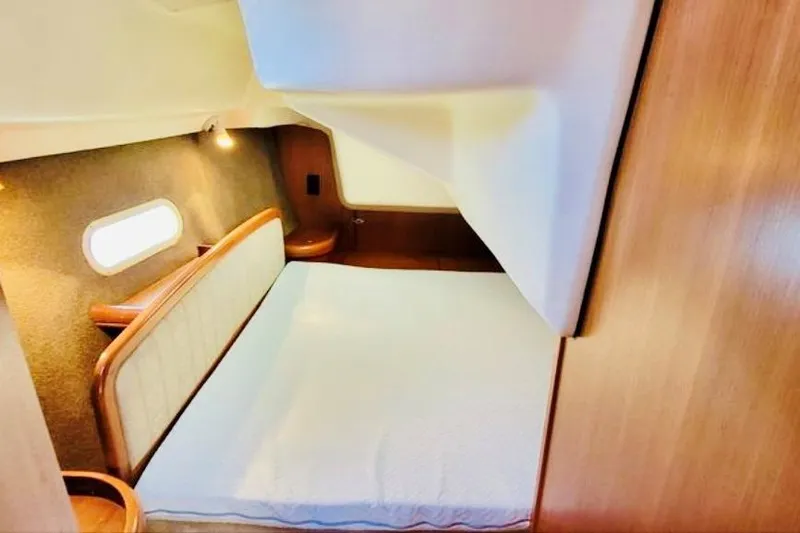 Slide: The Image of Cozy cabin interior of 2002 Hunter 356 sailboat with wooden accents and soft lighting. - 10