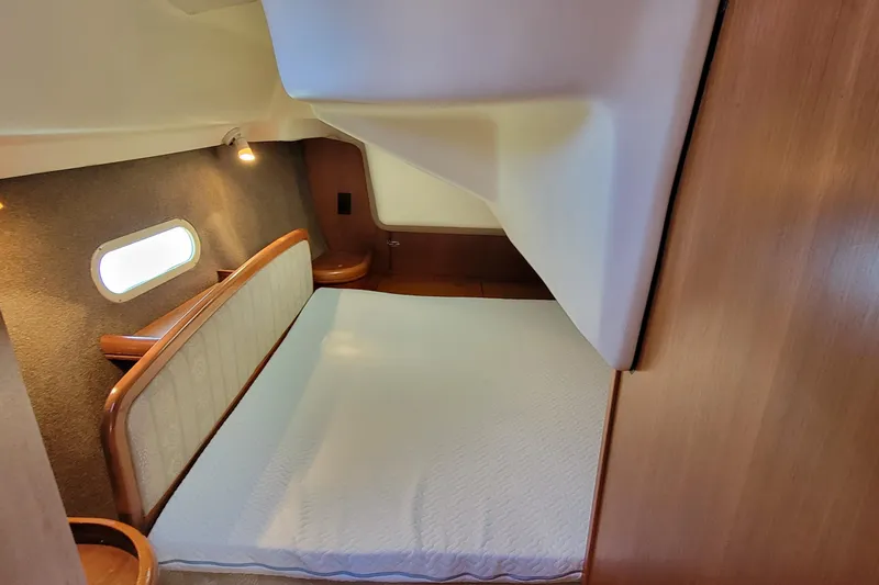 Slide: The Image of Cozy cabin interior of a 2002 Hunter 356 sailboat with a comfortable bed. - 3