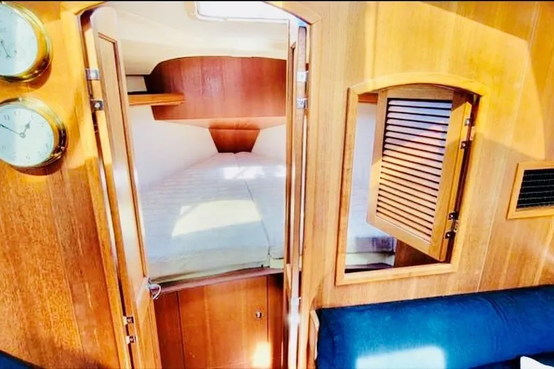 Slide: The Image of Interior cabin of a 2002 Hunter 356 sailboat with wooden finish and cozy bed. - 7