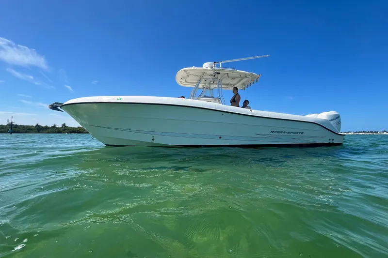 The Image of A white Hydra-Sports boat on calm water under a blue sky. - 0